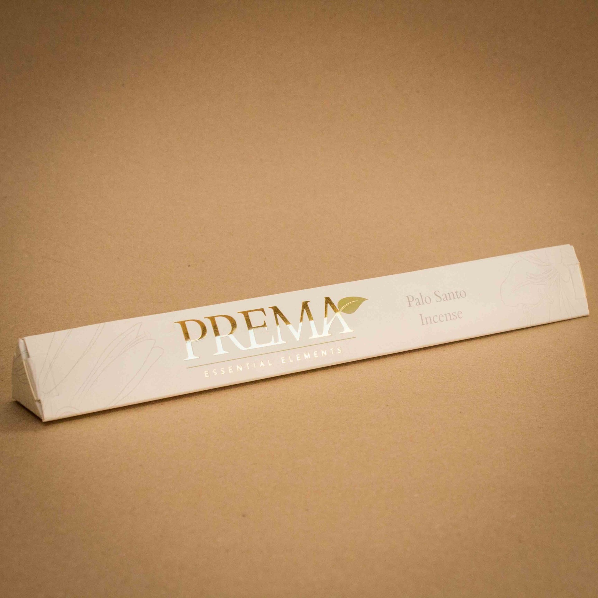 Prema Essential Elements Palo Santo incense triangular carton with gold foil logo Prema Essential Elements Palo Santo incense triangular carton with gold foil logo