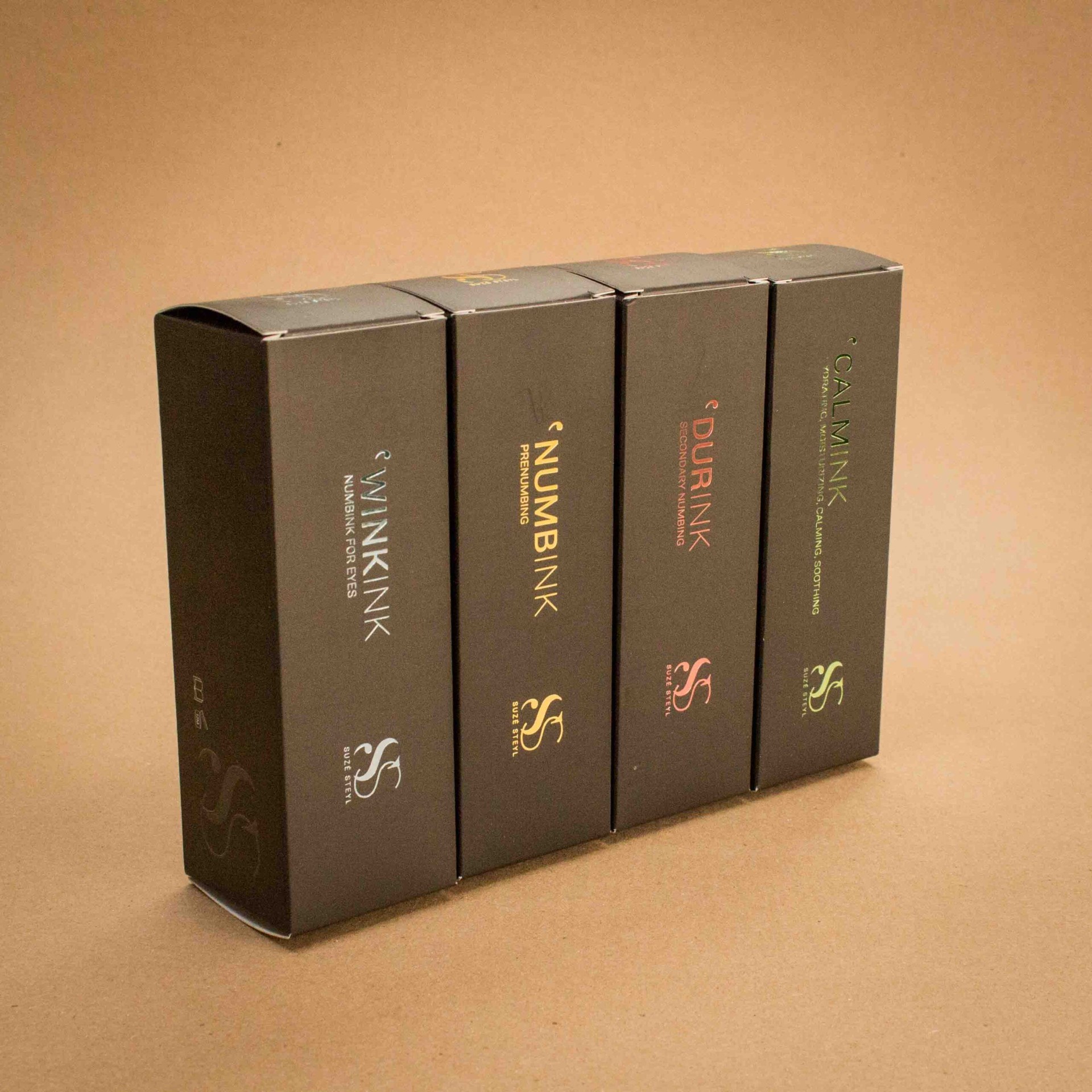 Suze Steyl Numbink tattoo aftercare range in matte black folding cartons with foil accents Suze Steyl Numbink tattoo aftercare range in matte black folding cartons with foil accents