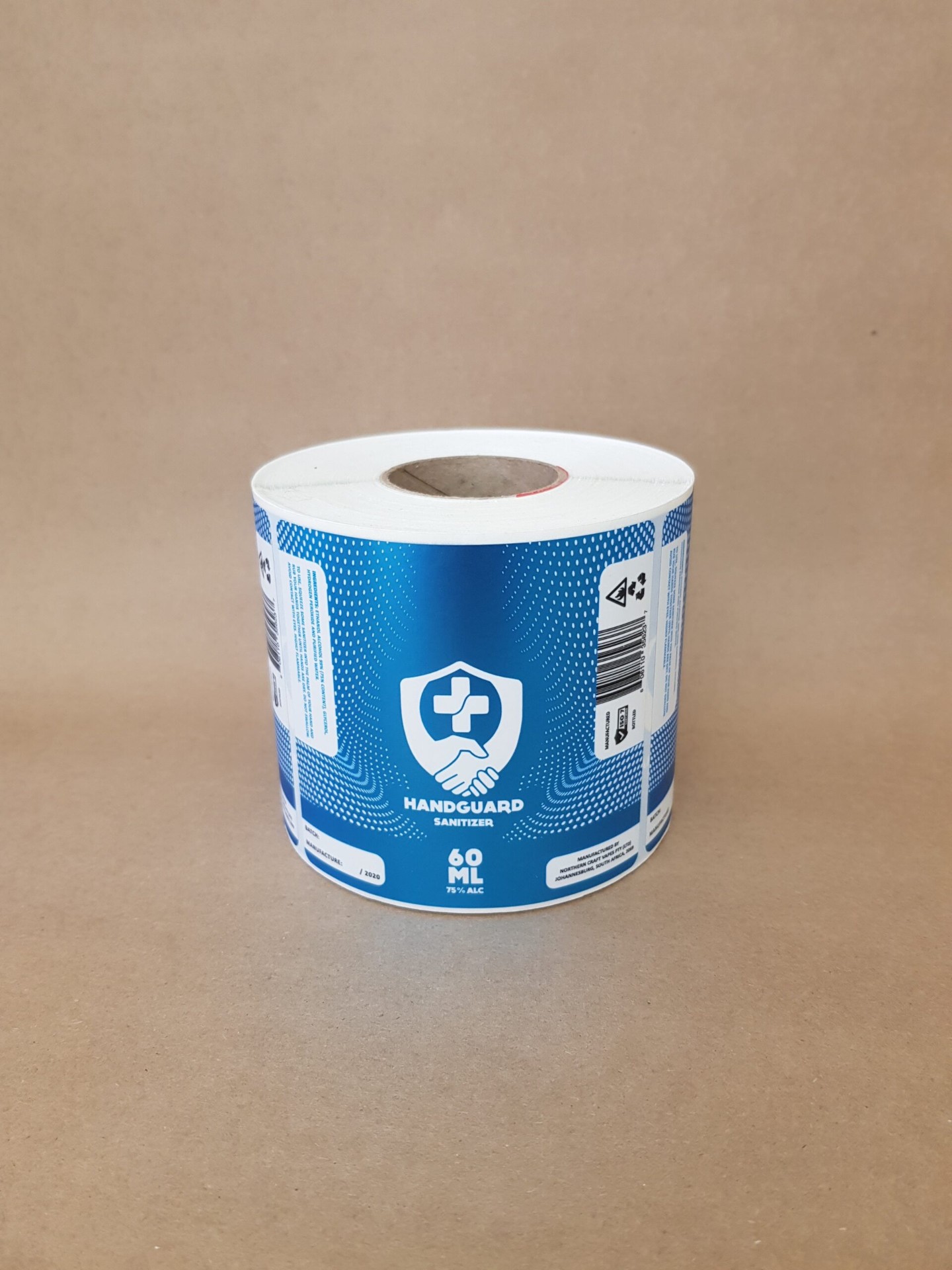 Handguard Sanitizer 60ml self-adhesive label roll in blue with shield logo Handguard Sanitizer 60ml self-adhesive label roll in blue with shield logo