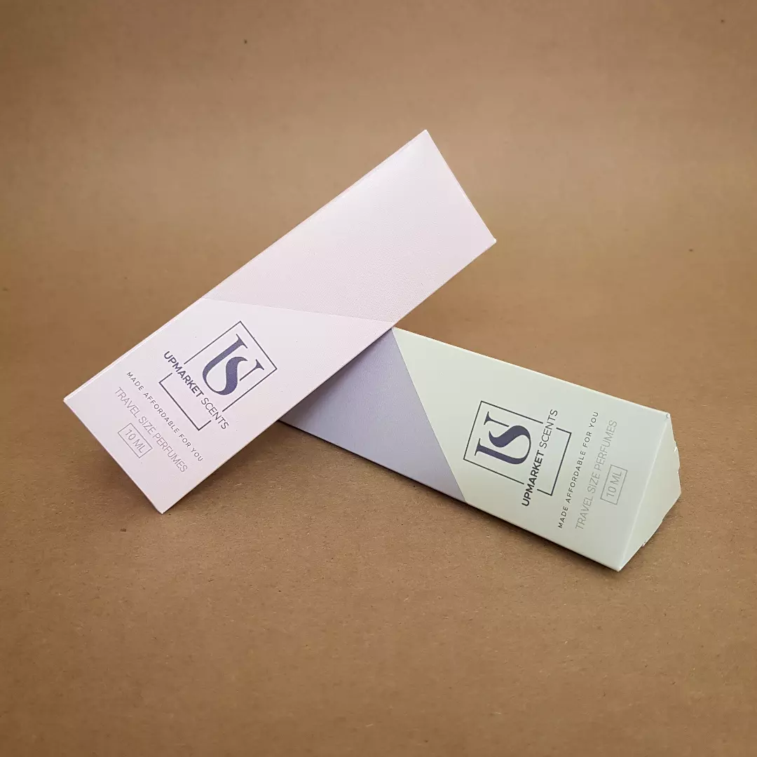 Upmarket Scents 10ml travel size perfume triangular folding cartons in blush pink and sage green Upmarket Scents 10ml travel size perfume triangular folding cartons in blush pink and sage green
